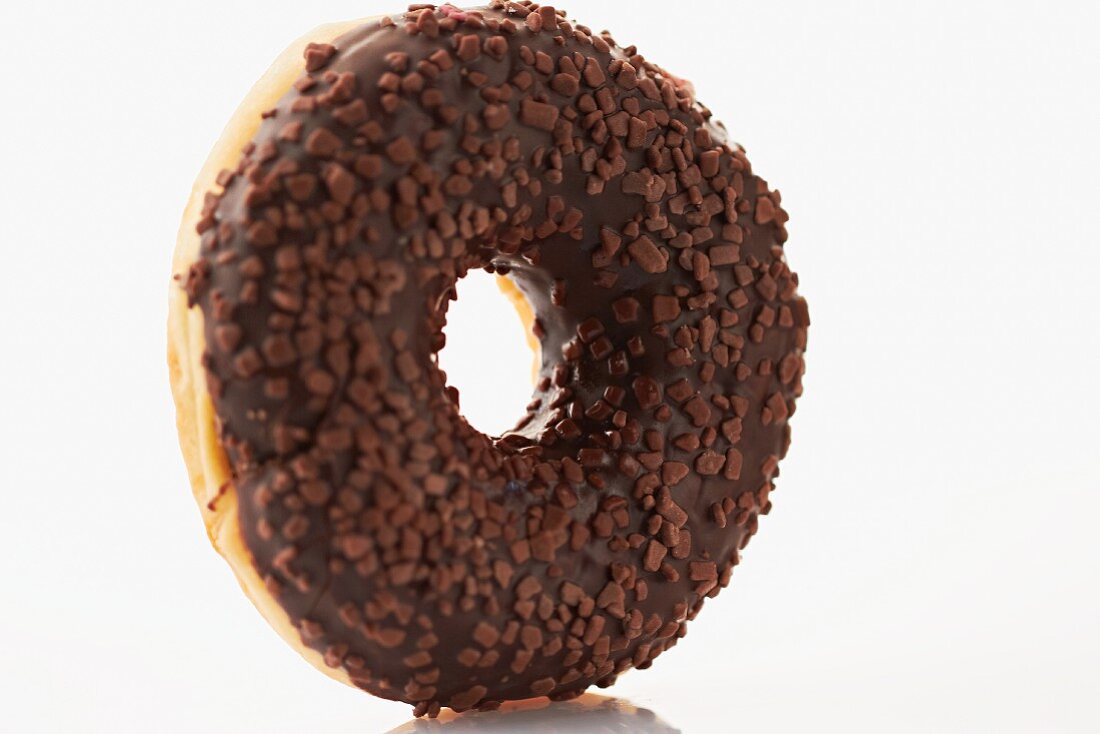 A doughnut with chocolate glaze and chocolate sprinkles