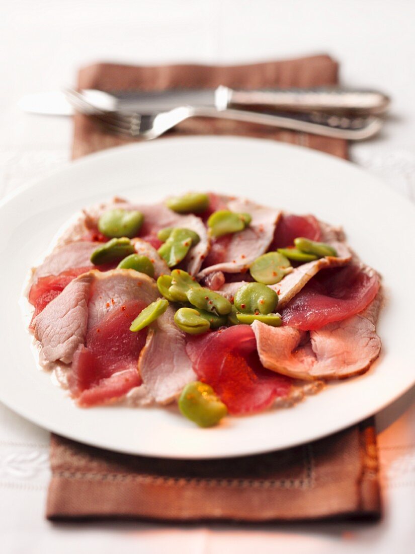 Veal carpaccio with broad beans