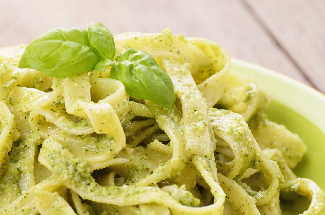 Tagliatelle with pesto and fresh basil (close-up)