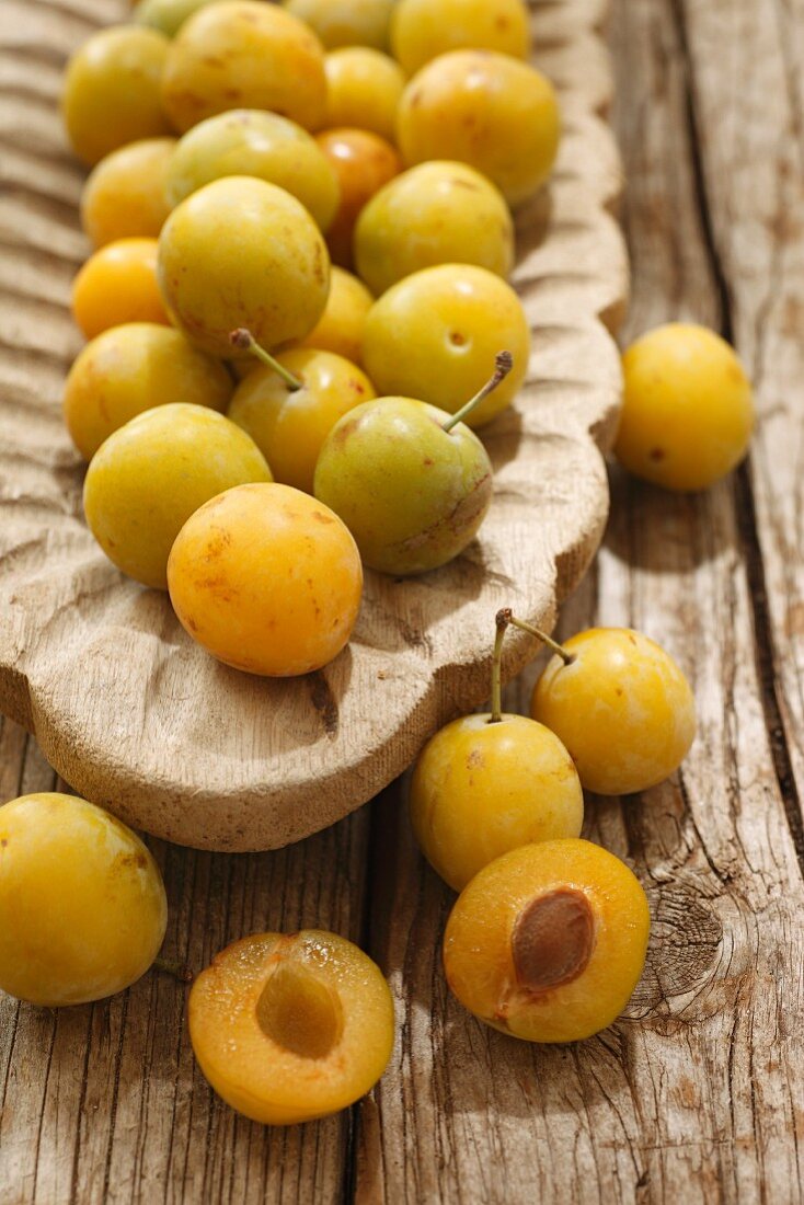 Mirabelles in a wooden bowl and next to it