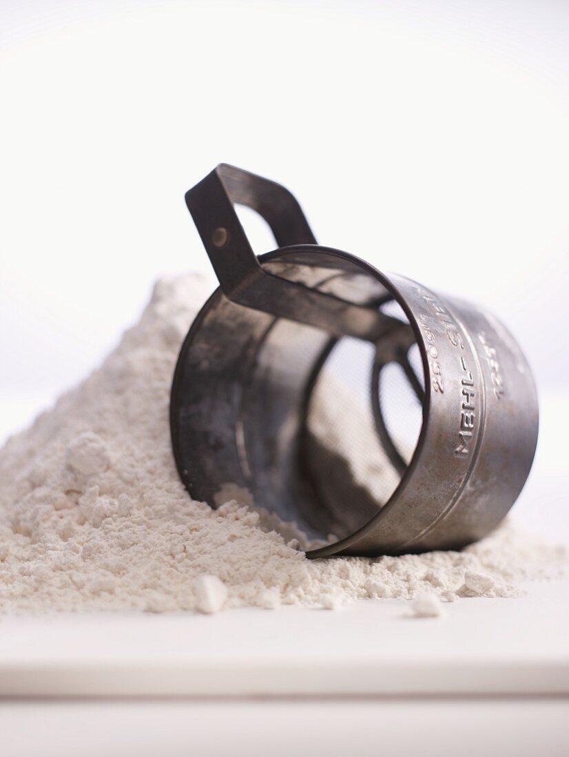 A flour dredger in a pile of flour