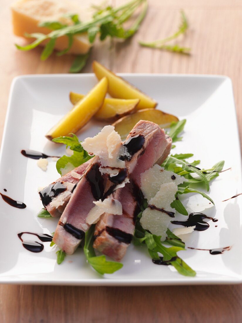 Tuna on a bed of rocket with Parmesan shavings and balsamic cream