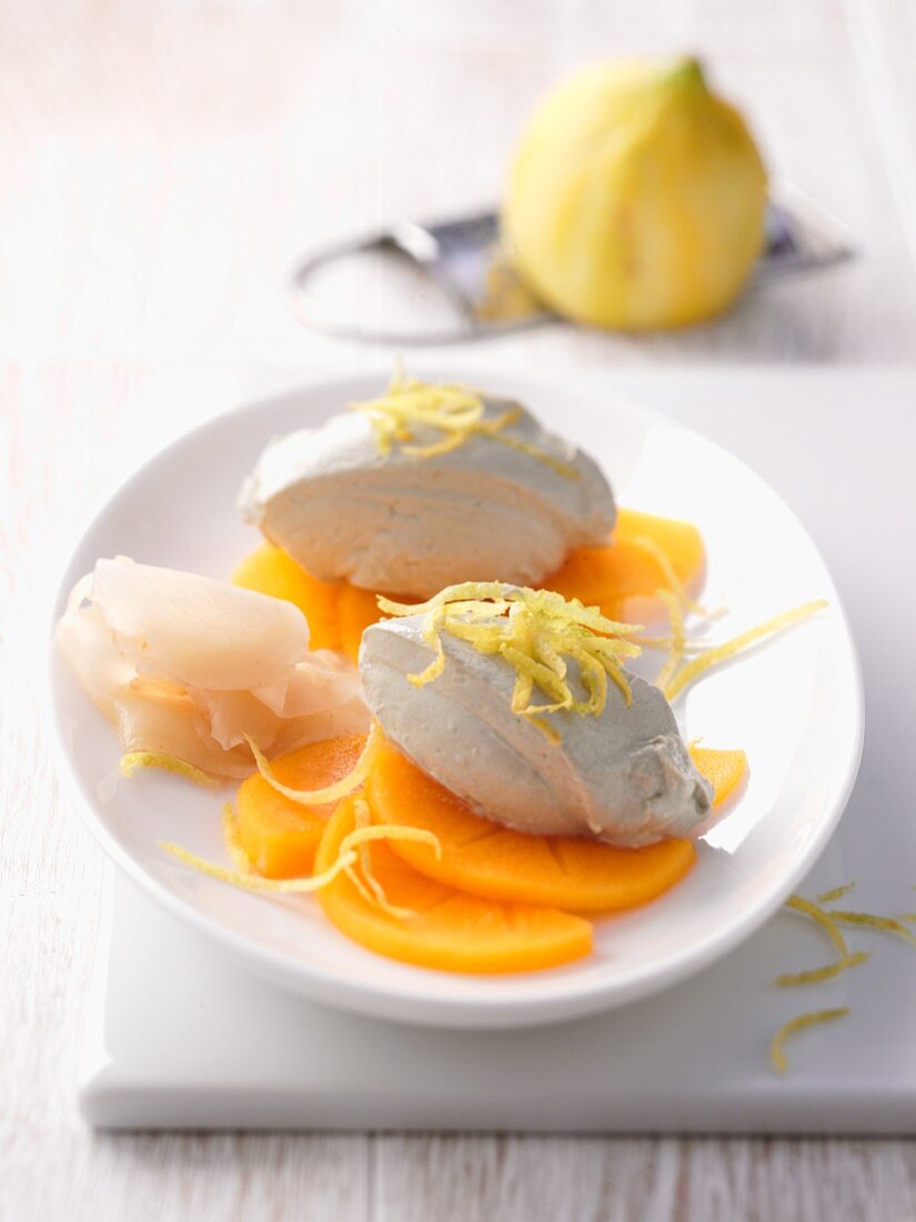 Goat's cream on persimmon slices with lemon zest and preserved ginger