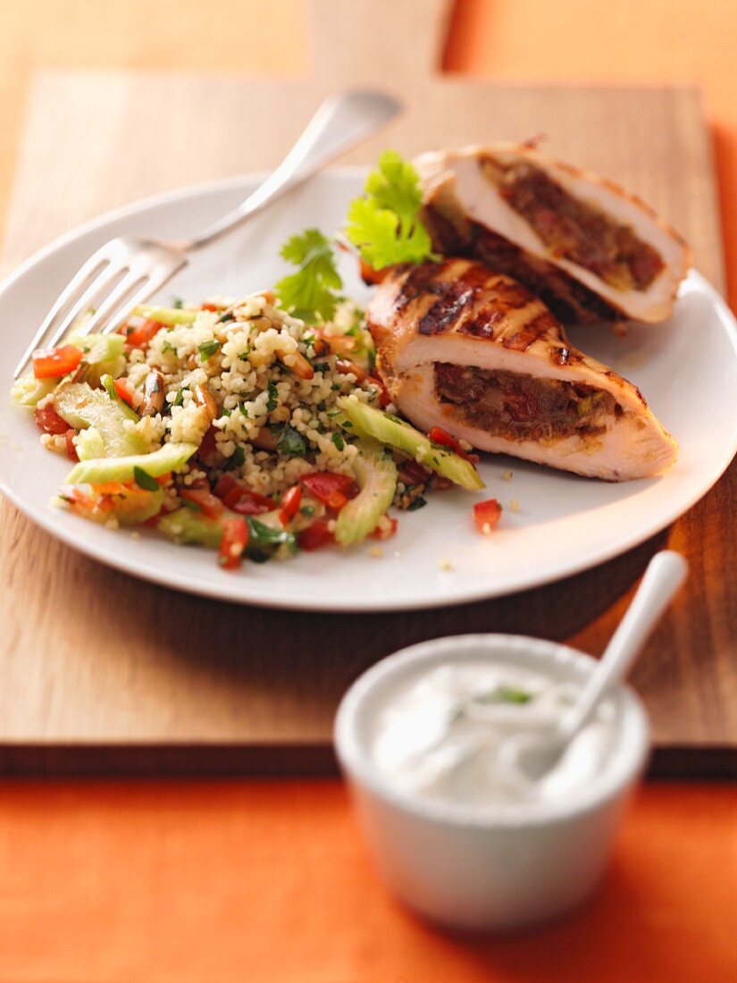 Chicken breast filled with dates with a couscous salad and a dip