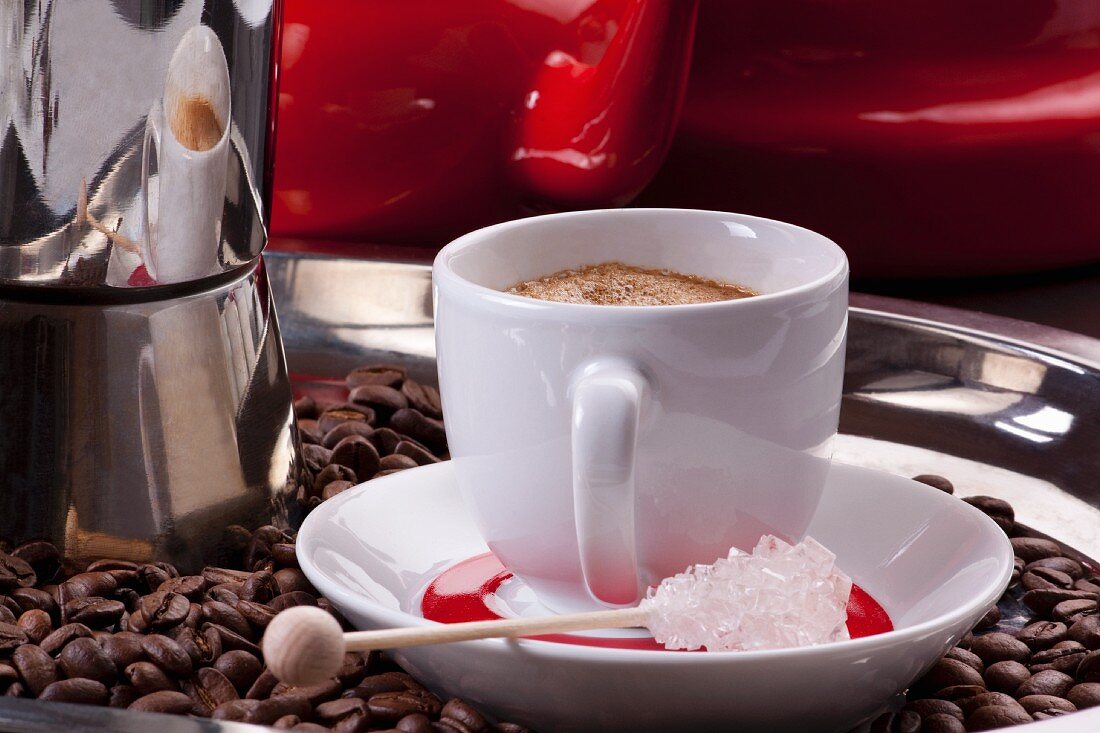 A coffee cup with fresh coffee and coffee beans