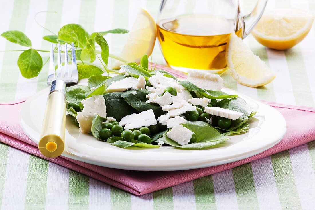 Spinach salad with fresh peas and feta cheese