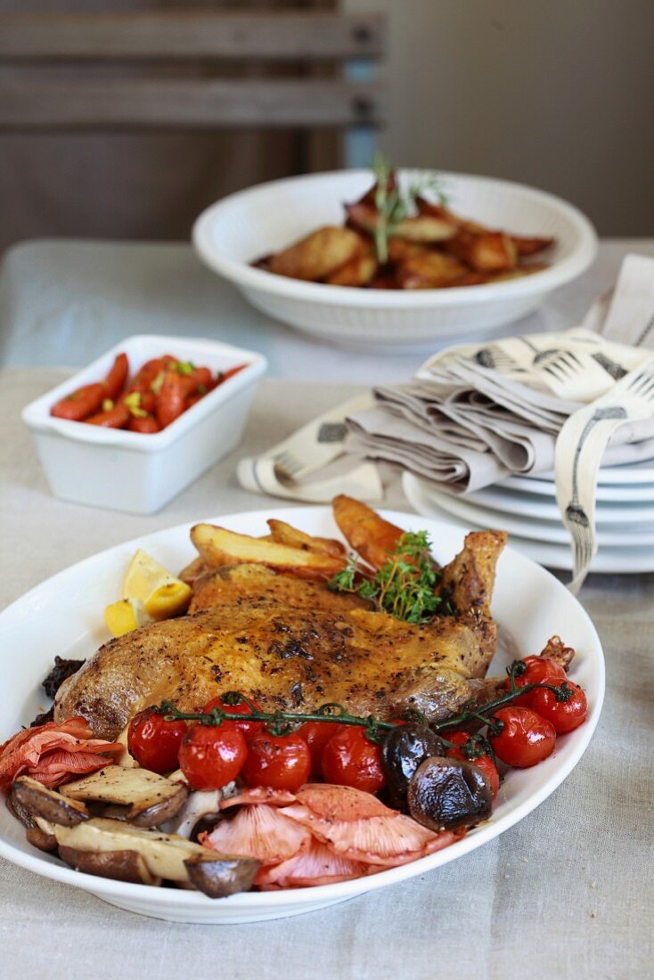 Duck with roast potatoes, mushrooms and cherry tomatoes