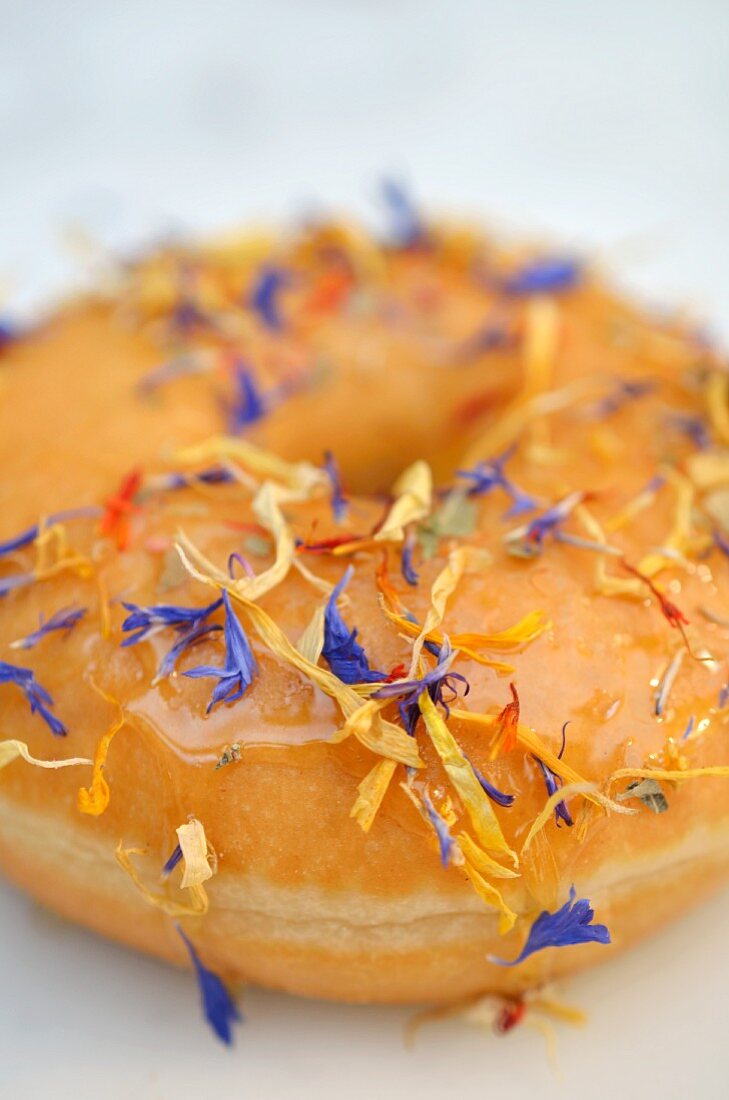 A doughnut decorated with dried flowers