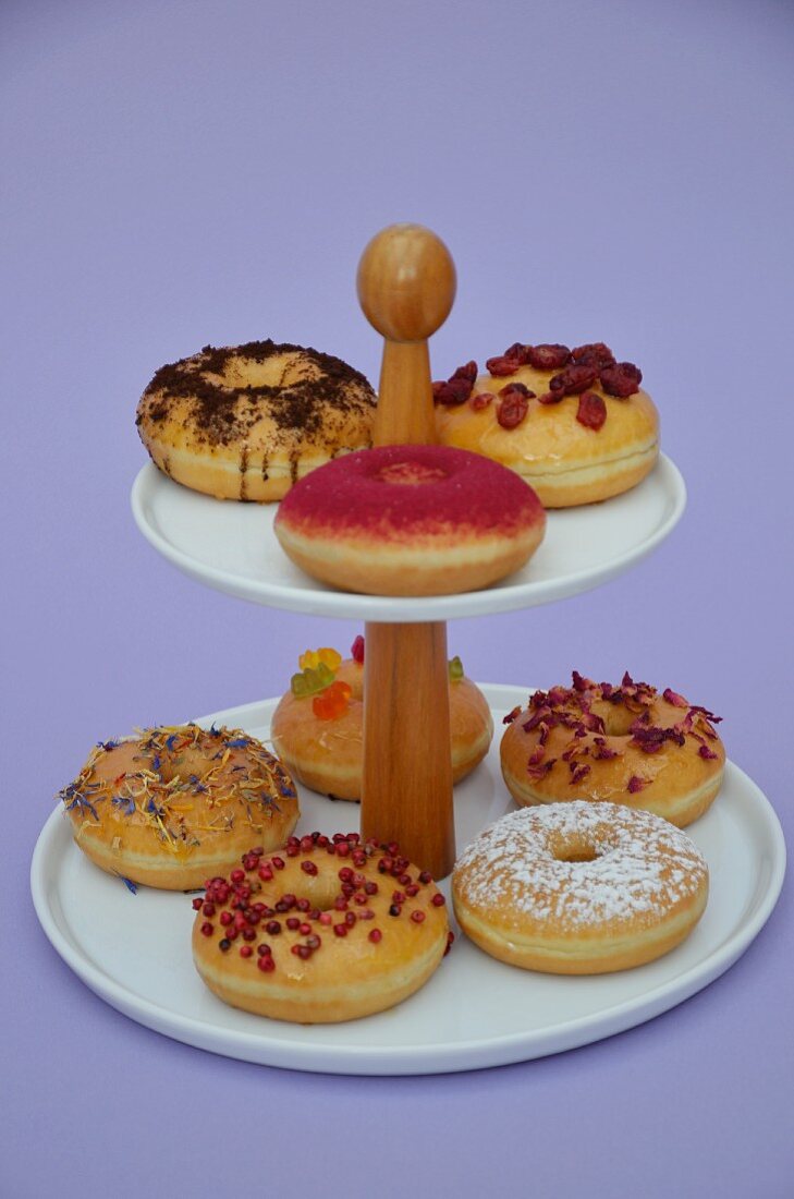 Doughnuts with various toppings on a cake stand
