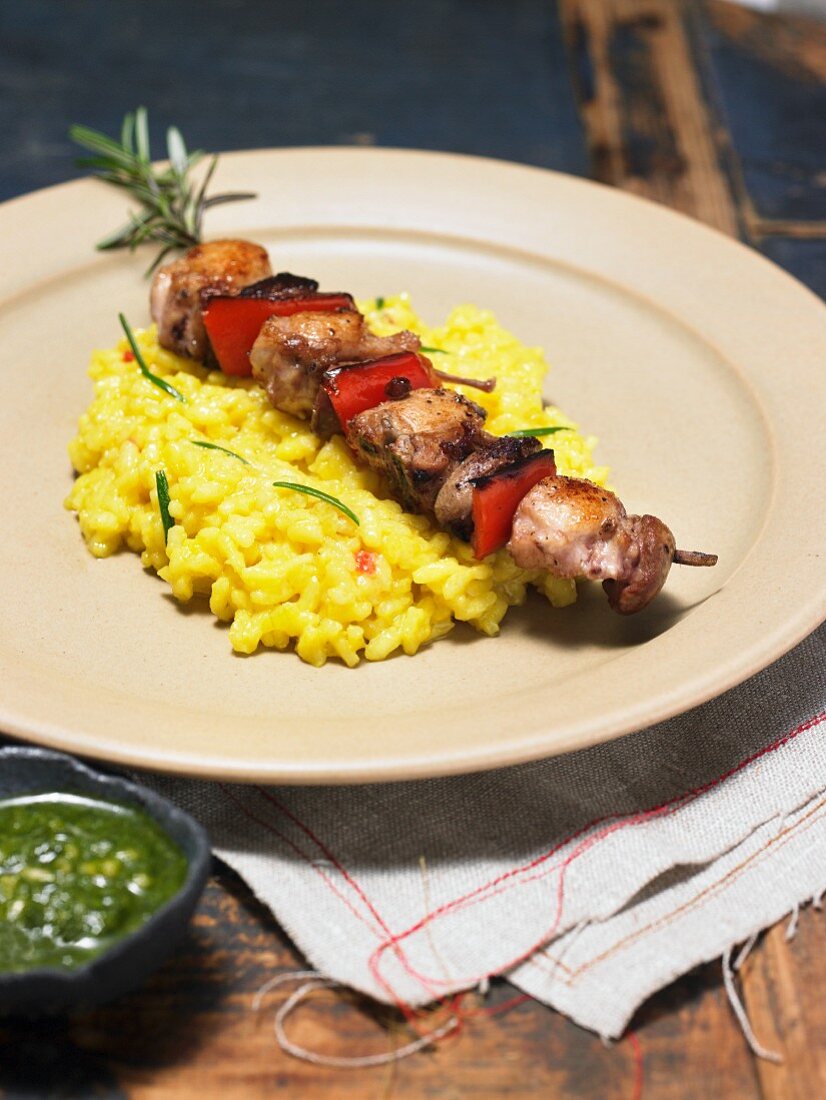 Rosemary and rabbit kebab on a bed of risotto
