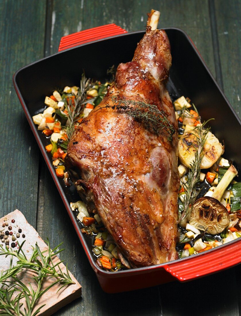 Roast leg of lamb on a bed of vegetables