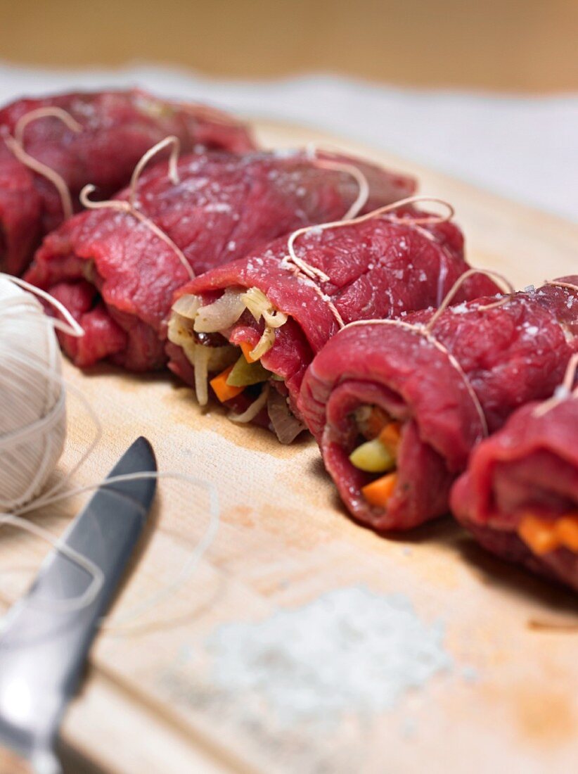 Raw beef roulade on a chopping board