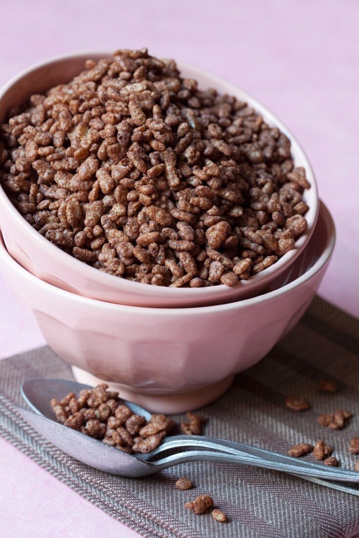 Chocolate rice puffs in a stack of bowls