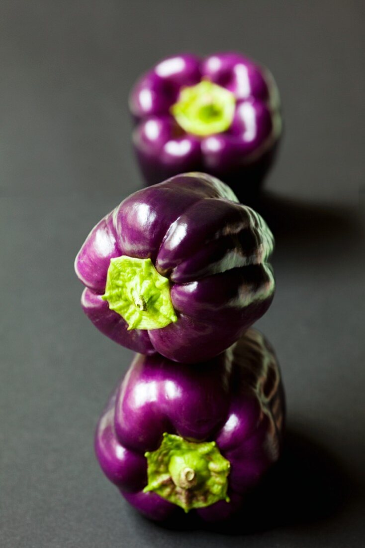 Three purple peppers