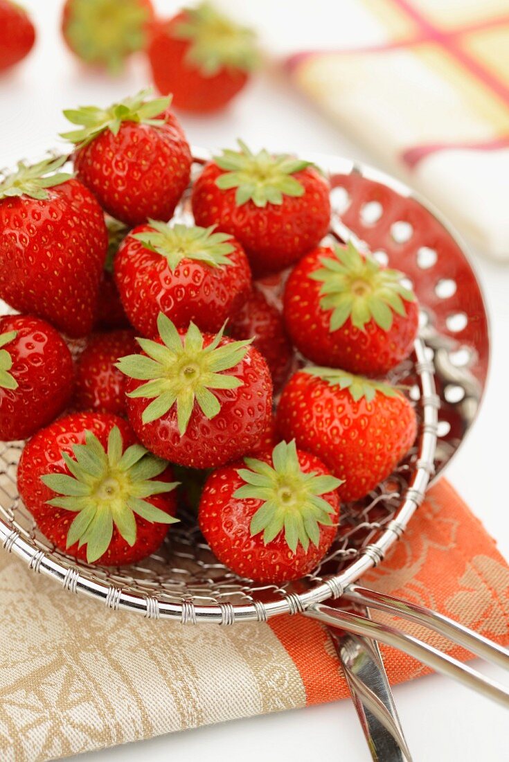 Fresh strawberries on a draining spoon
