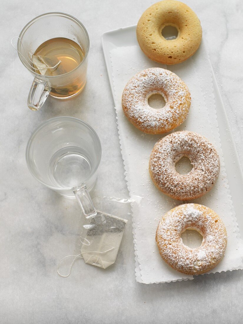 Three Powdered Sugar Donuts and One Plain; Cup of Tea