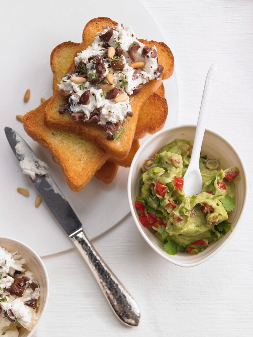Bruschetta topped with goat's cheese and pine nuts with guacamole