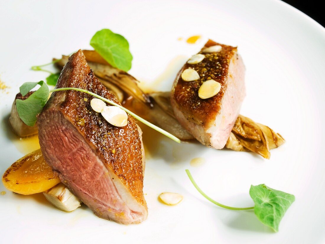 Fried duck breast with apricot sauce and slivered almonds