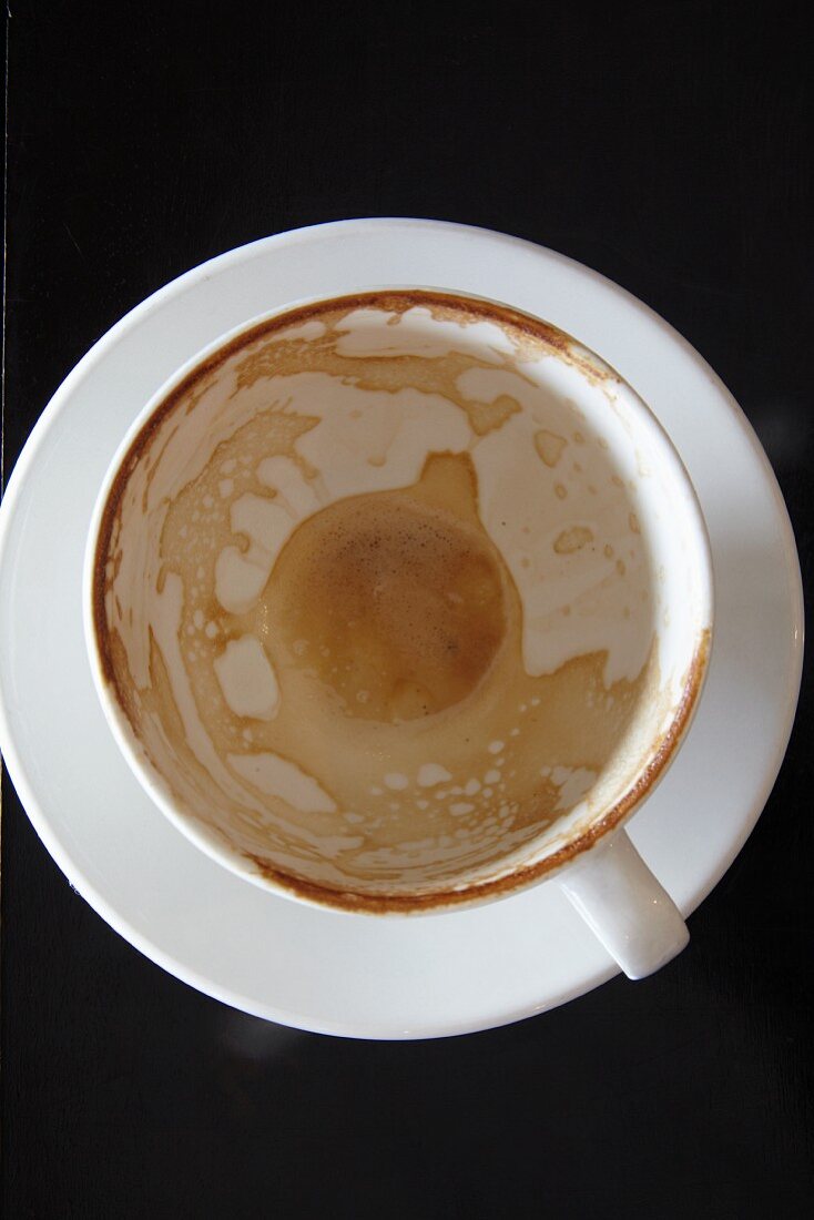 An empty cappuccino cup