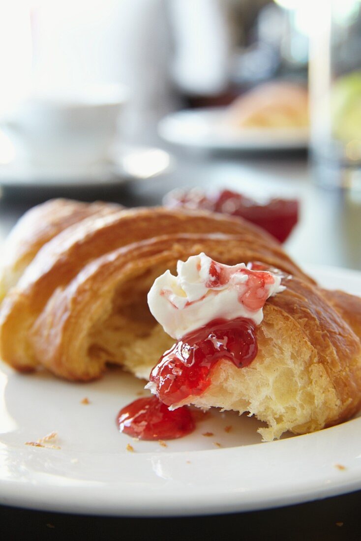 A croissant with butter and jam