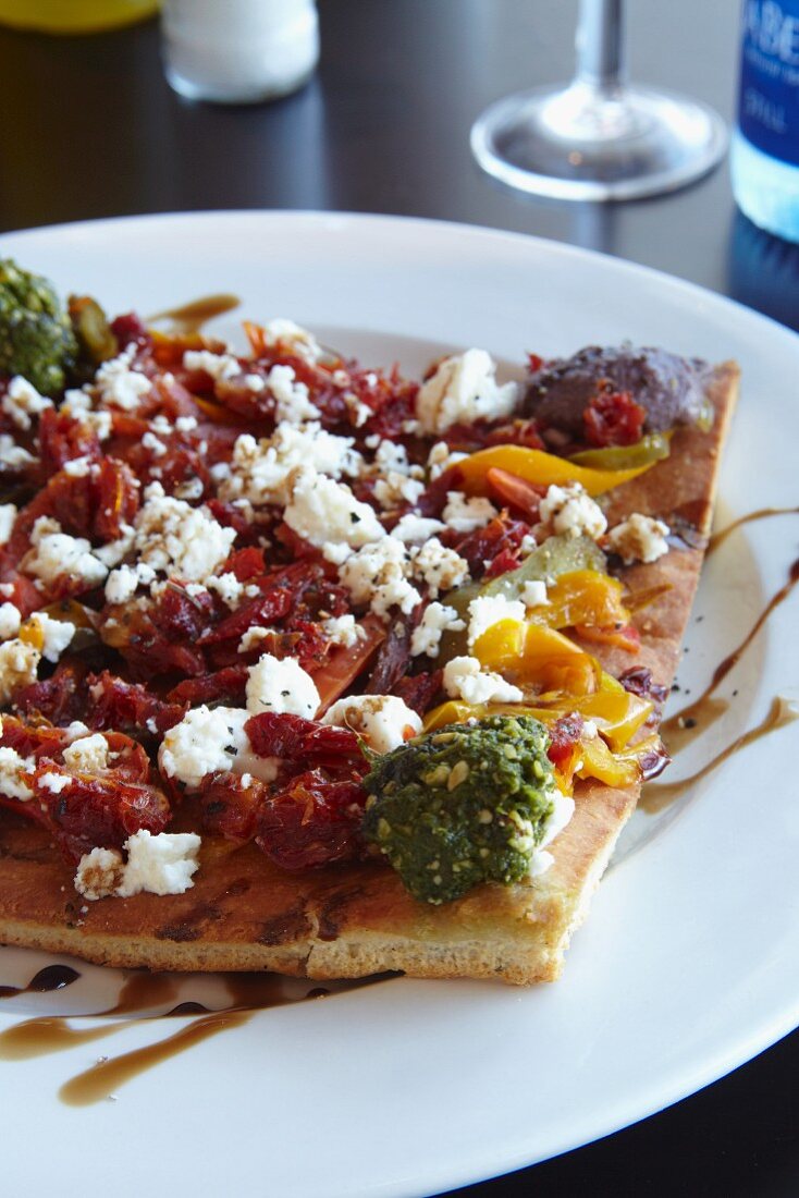 Unleavened bread topped with peppers and feta cheese