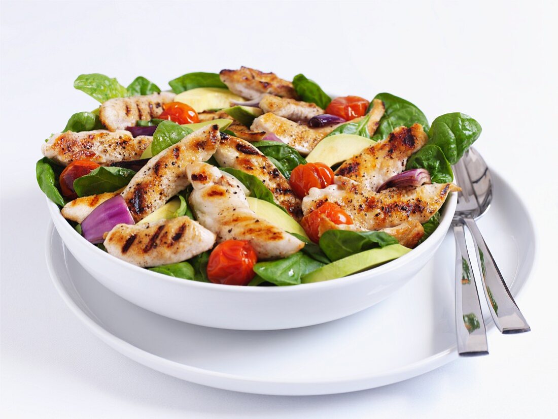 Grilled chicken salad with spinach and tomatoes