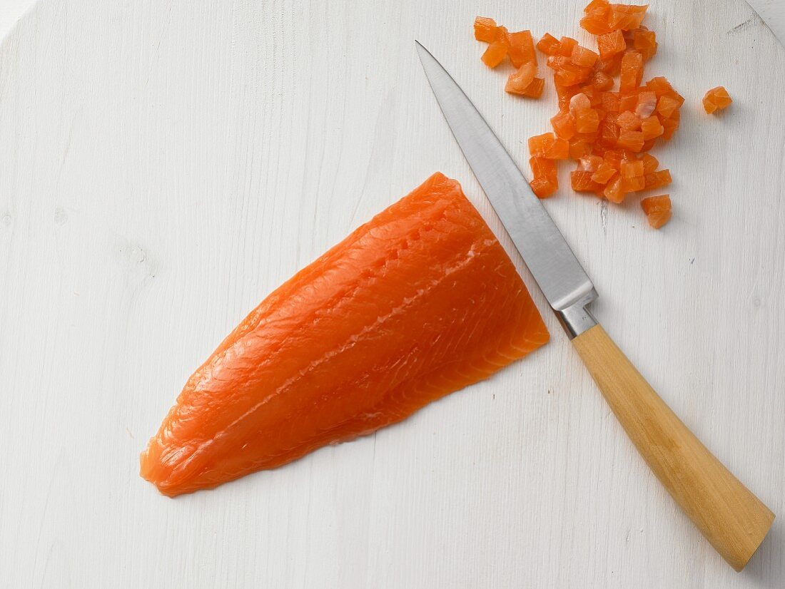 A fish fillet being diced