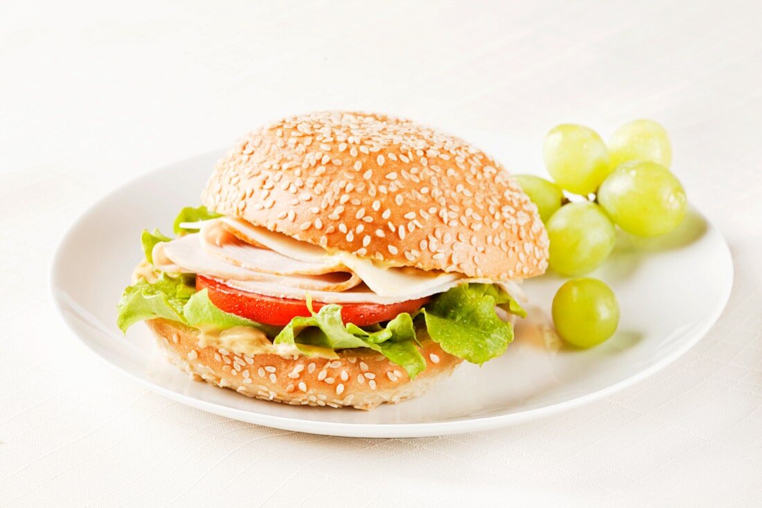 Turkey Sandwich on a Sesame Seed Bun with Green Grapes