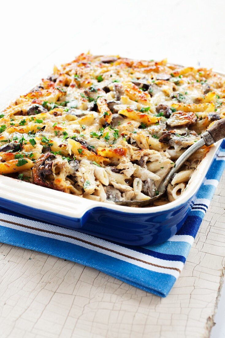 Baked Penne, Chicken and Mushroom Casserole in Casserole Dish; Serving Spoon