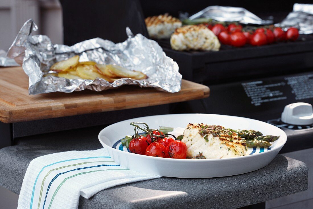 Grilled halibut with vine tomatoes and baked potatoes