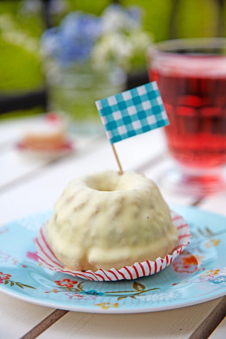 A mini Bundt cake with white chocolate glaze