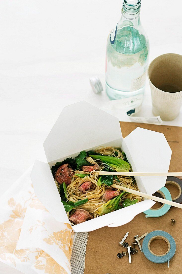 A salad of rice noodles with beef and broccoli