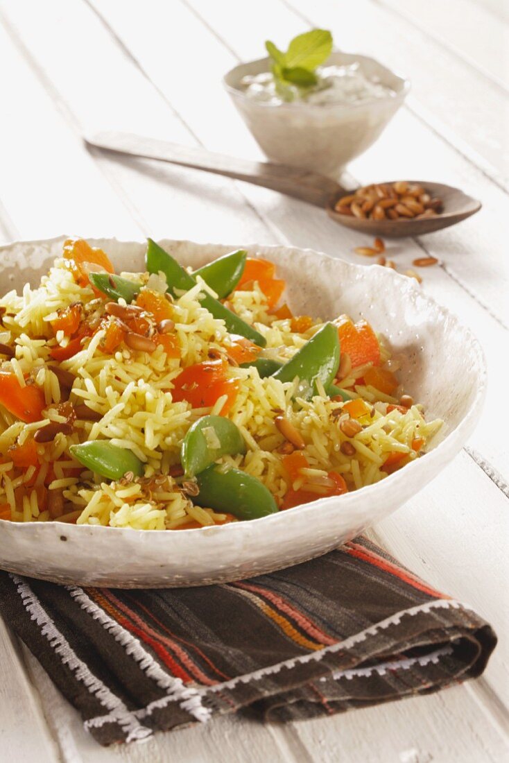 Saffron rice with vegetables and pine nuts