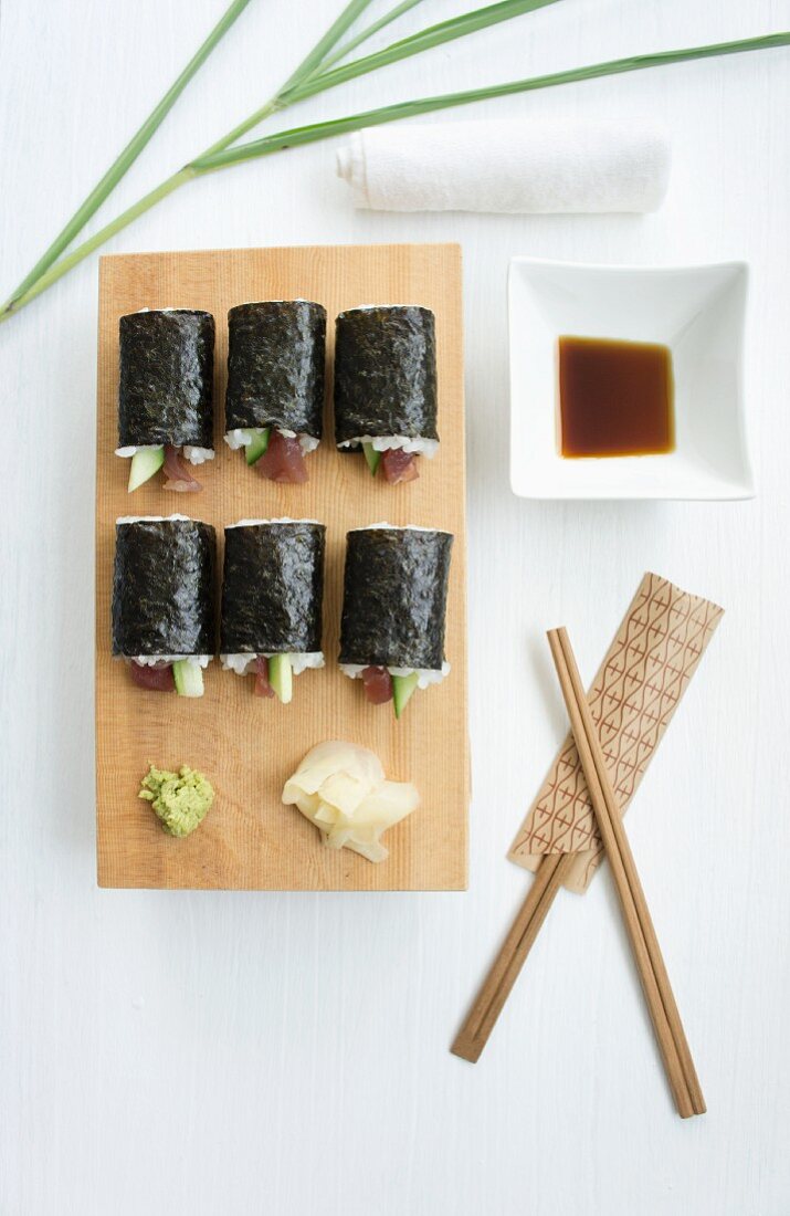 Tuna and cucumber sushi with soy sauce, wasabi and ginger