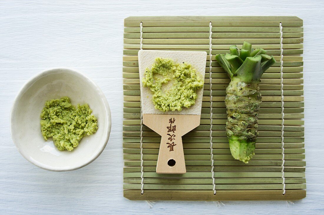Wasabi root with a traditional grater made of whale skin on a bamboo mat