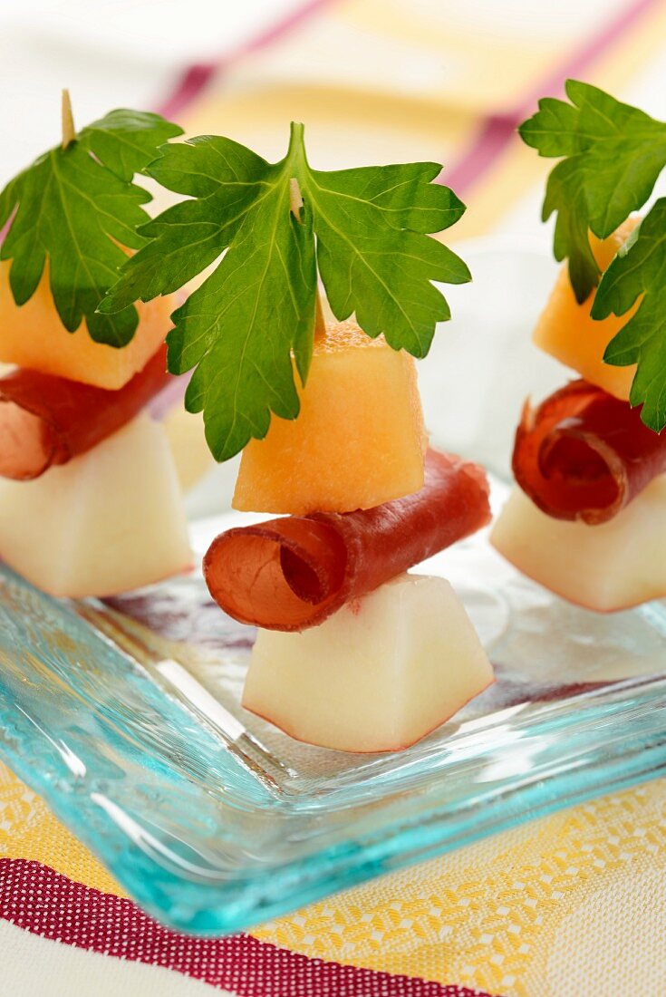Melon and peach kebabs with bresaola