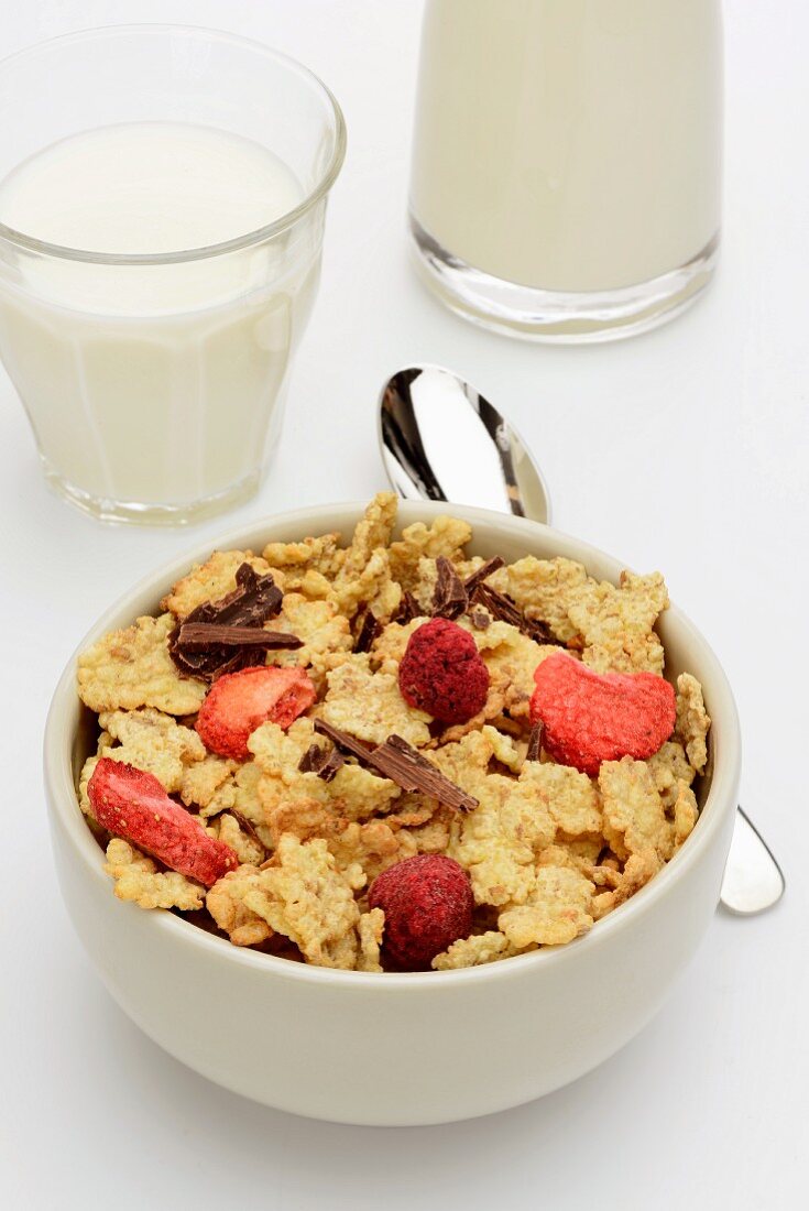 Cornflakes with dried fruit and chocolate and a glass of milk