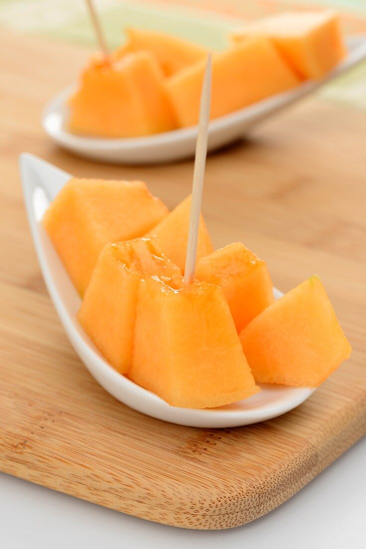 Diced melon with toothpicks