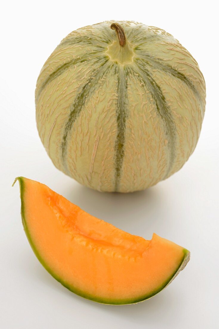 A whole cantaloupe melon and a wedge