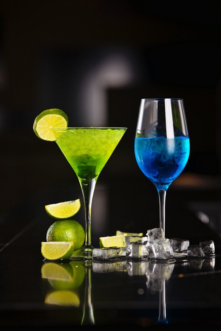 Two cocktails made with champagne, Blue Curacao and limes