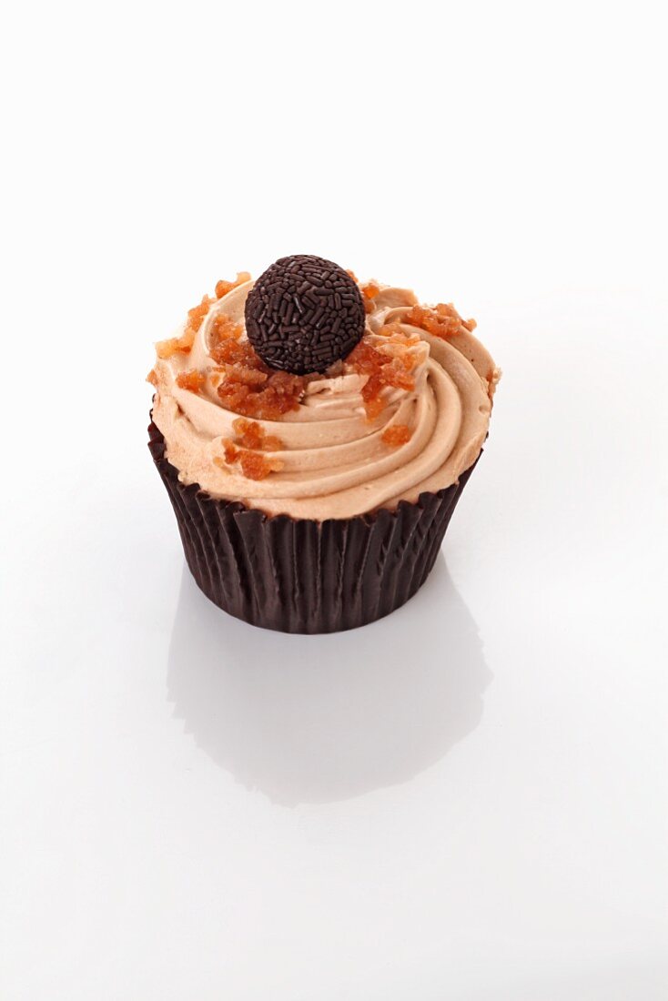 A cupcake decorated with a chocolate praline