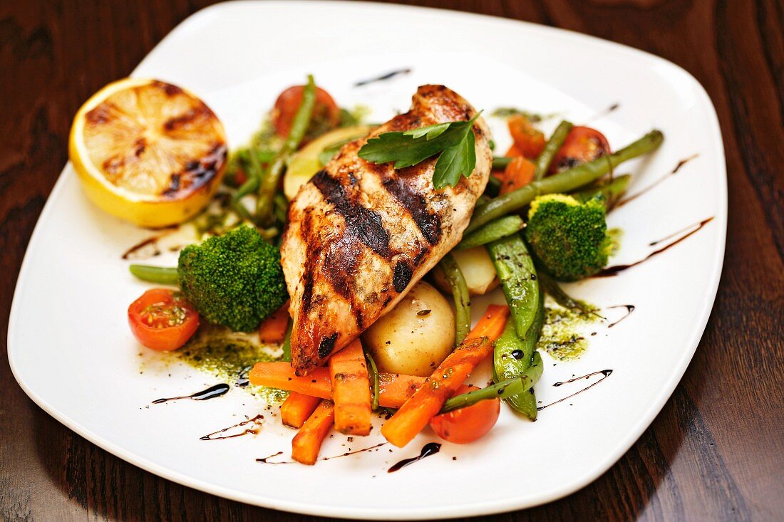 Grilled chicken breast on a bed of vegetables