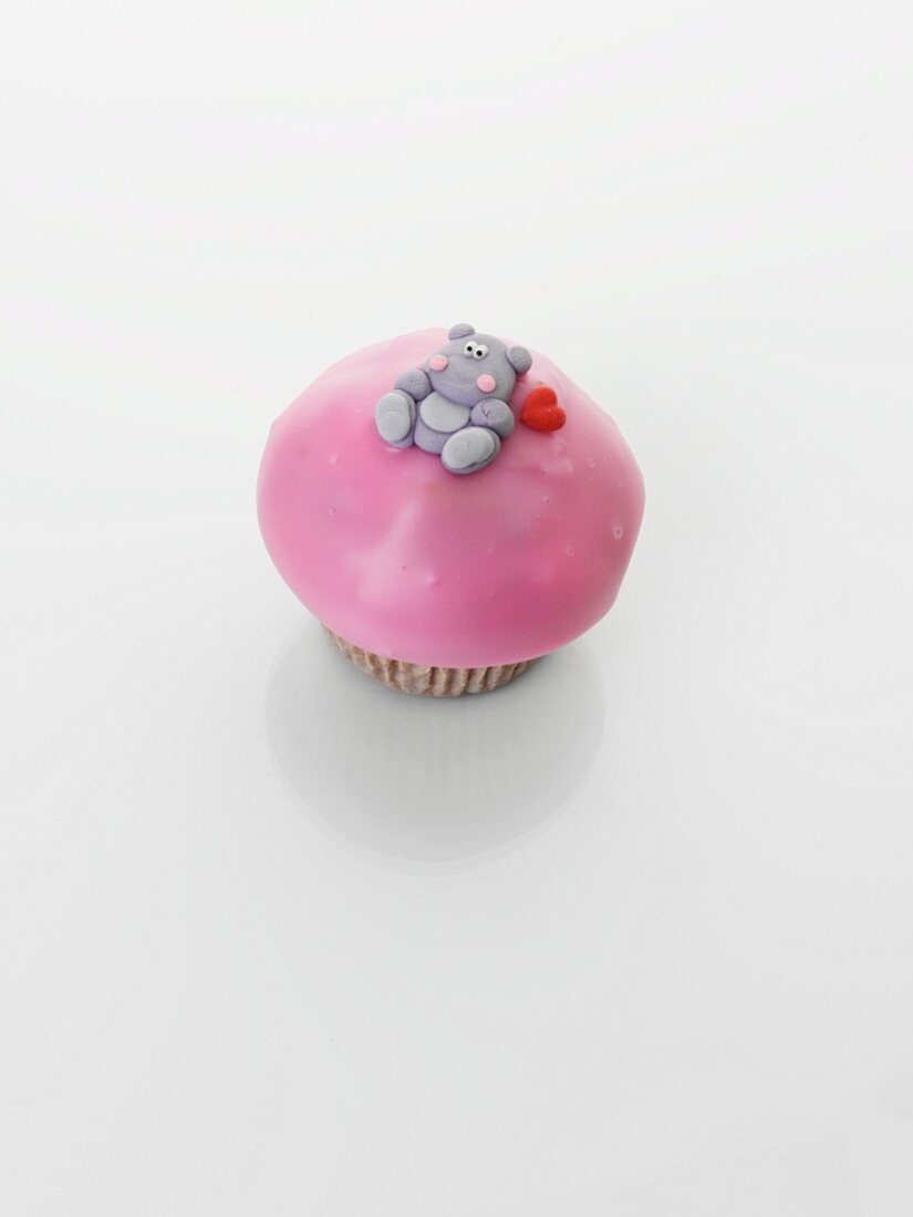 A cupcake decorated with a teddy bear
