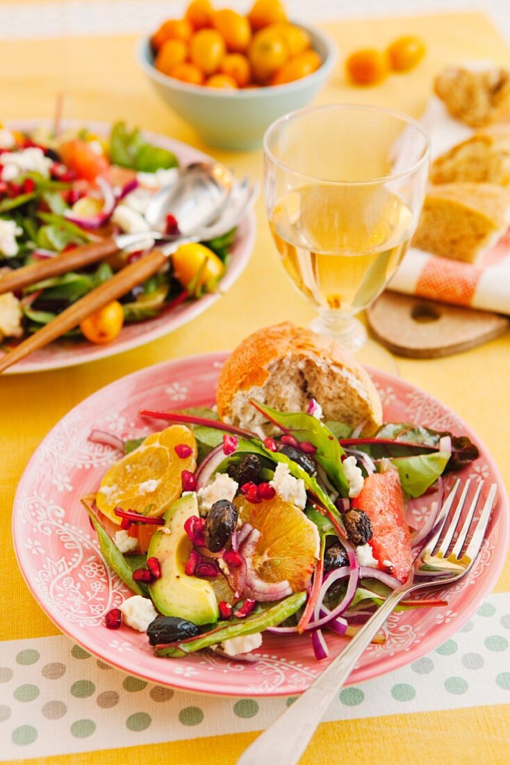 Citrus fruit salad with avocado, feta, olives and pomegranate seeds