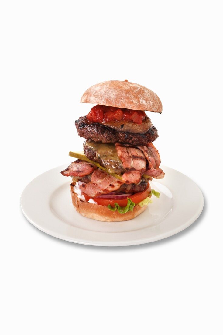 A giant burger with bacon and chilli sauce