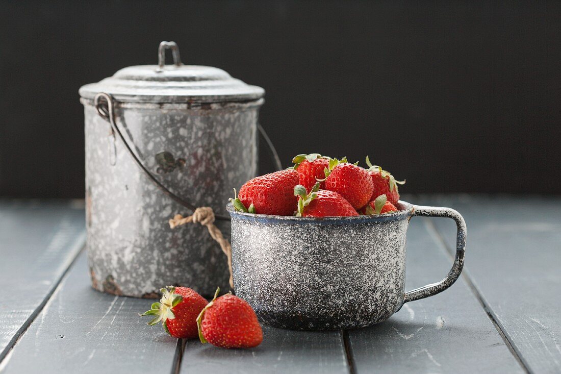 Fresh strawberries in an old measuring cup