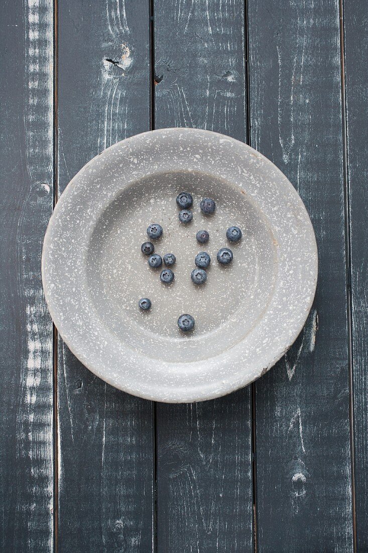 Blueberries on a grey enamel plate