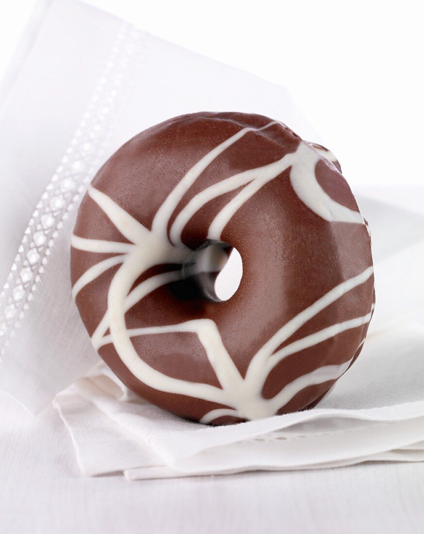 A doughnut with dark and white chocolate