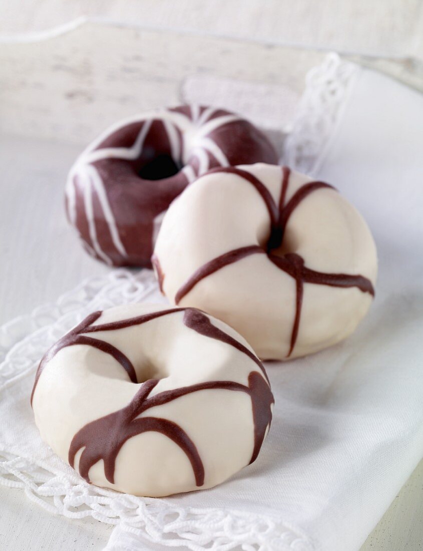 Doughnuts decorated with dark and white chocolate
