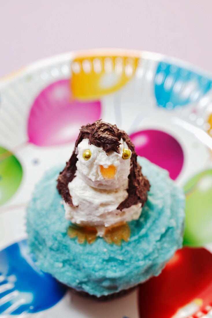 A cupcake decorated with a penguin